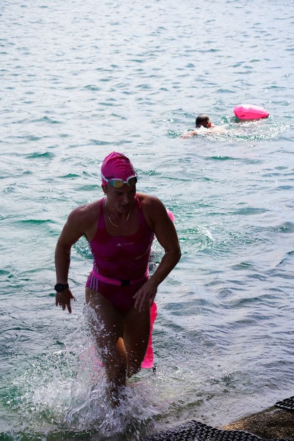A Deadly Swim racer running out of the lake after a swim
